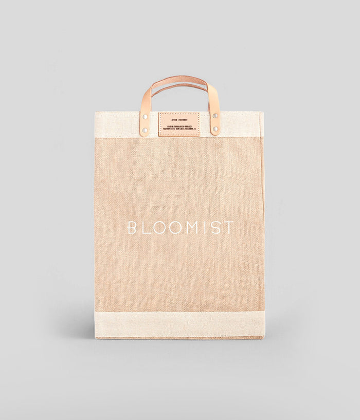 Bloomist-branded jute market tote with leather handles, spill-proof lining, and a spacious design for everyday use