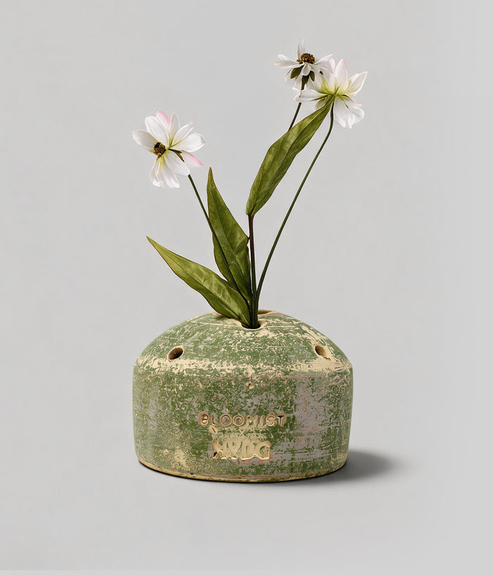 Bloomist x NYBG Garden Sage terracotta flower frog vase with white flowers, integrated stem openings, and impressed front branding