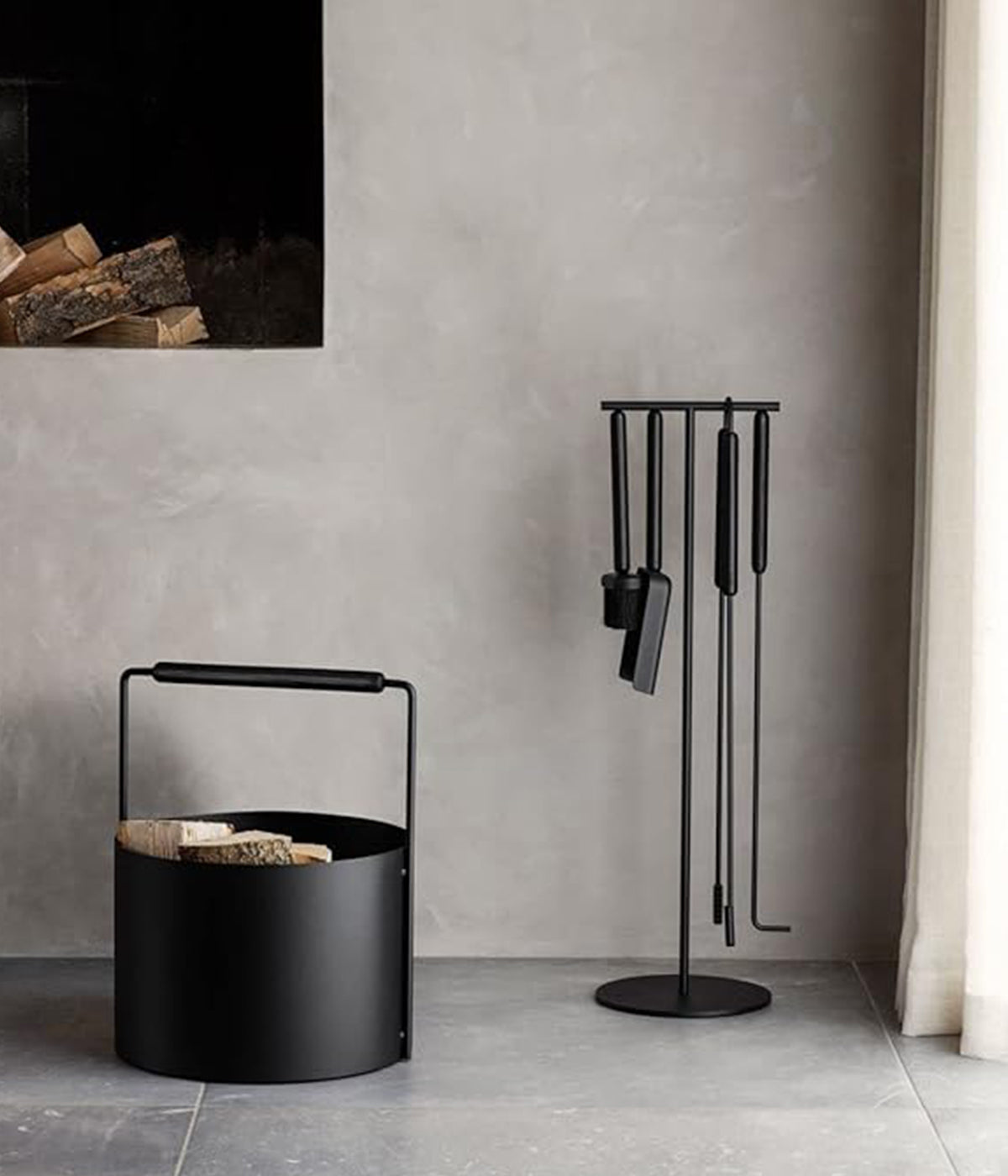 Modern hearthside firewood holder in black steel and oak from Ashi collection