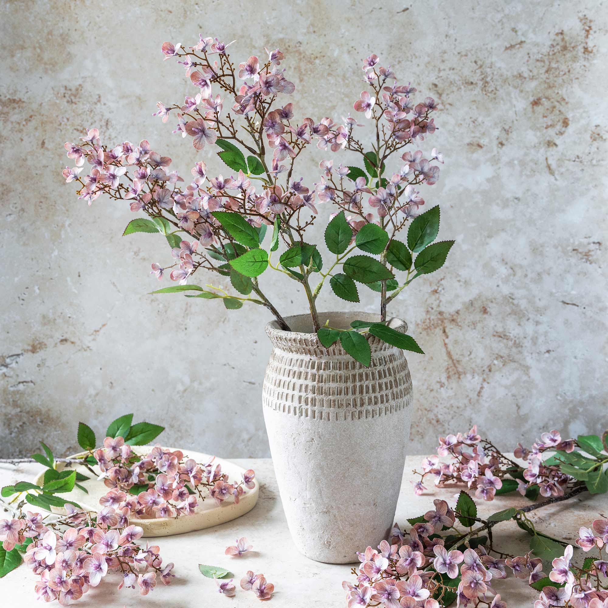 Artificial cherry blossom branches in soft blush with open branching form