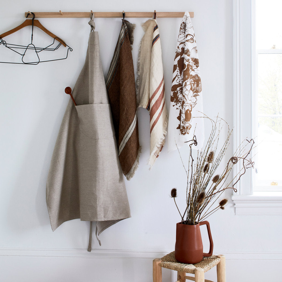 Soft flax towel on wooden rack ideal for drying hands in kitchen or guest bath