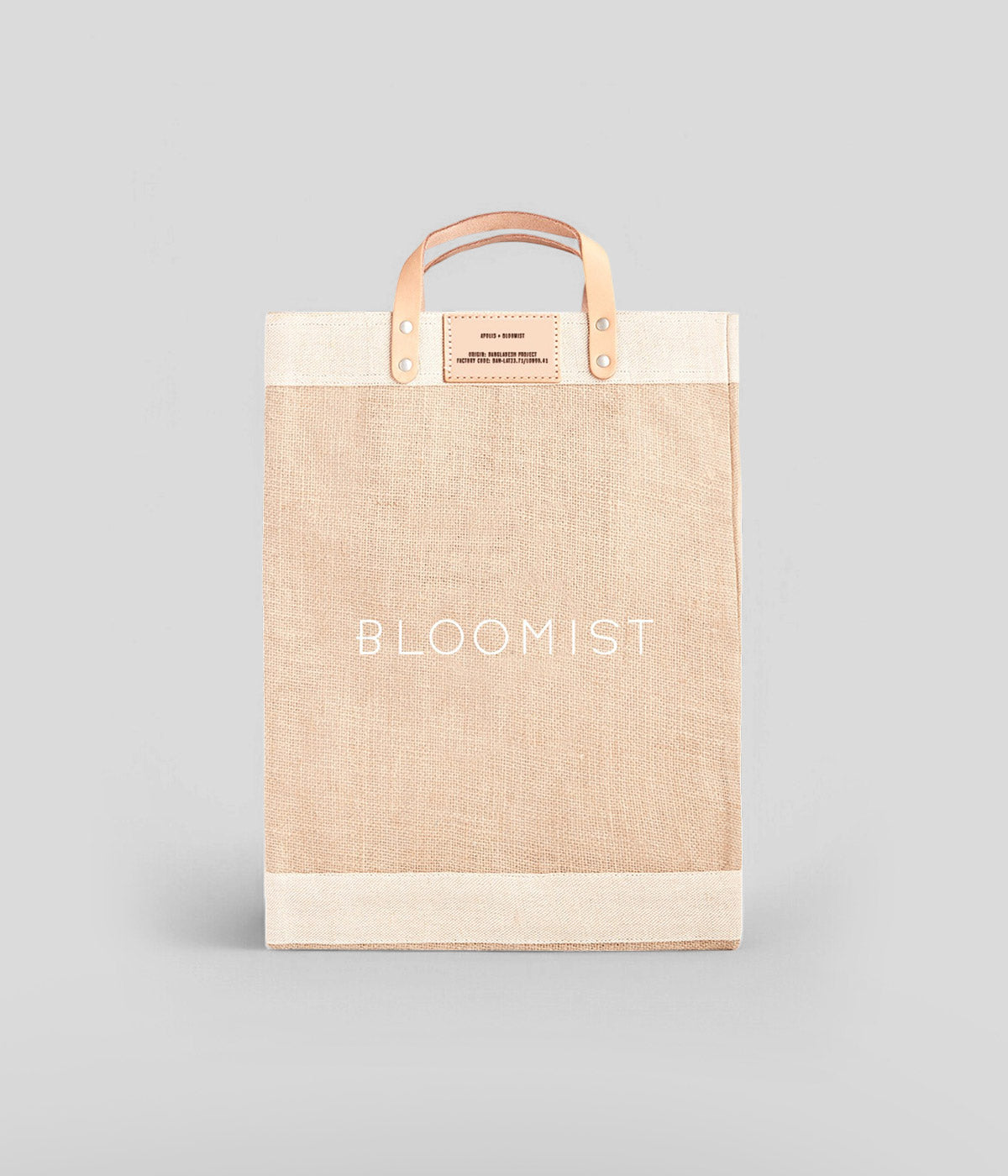 Bloomist-branded jute market tote with leather handles, spill-proof lining, and a spacious design for everyday use