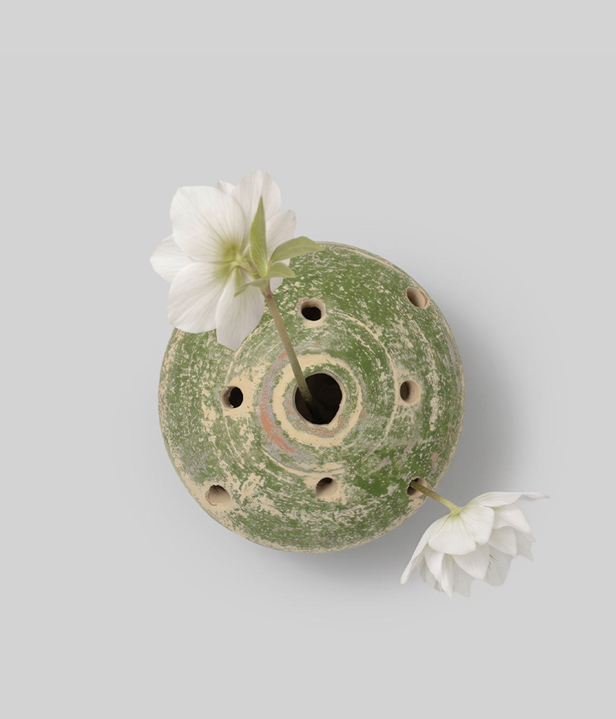 Top view of the Garden Sage terracotta flower frog vase with integrated openings holding two white flower stems