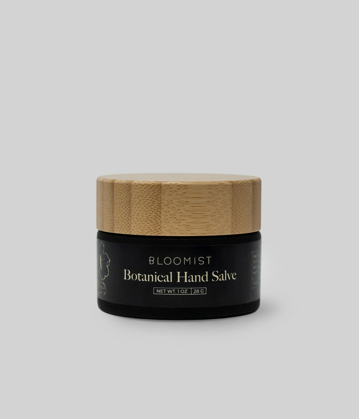 Multi-Use Botanical Skin Salve in a dark glass jar with a wooden lid