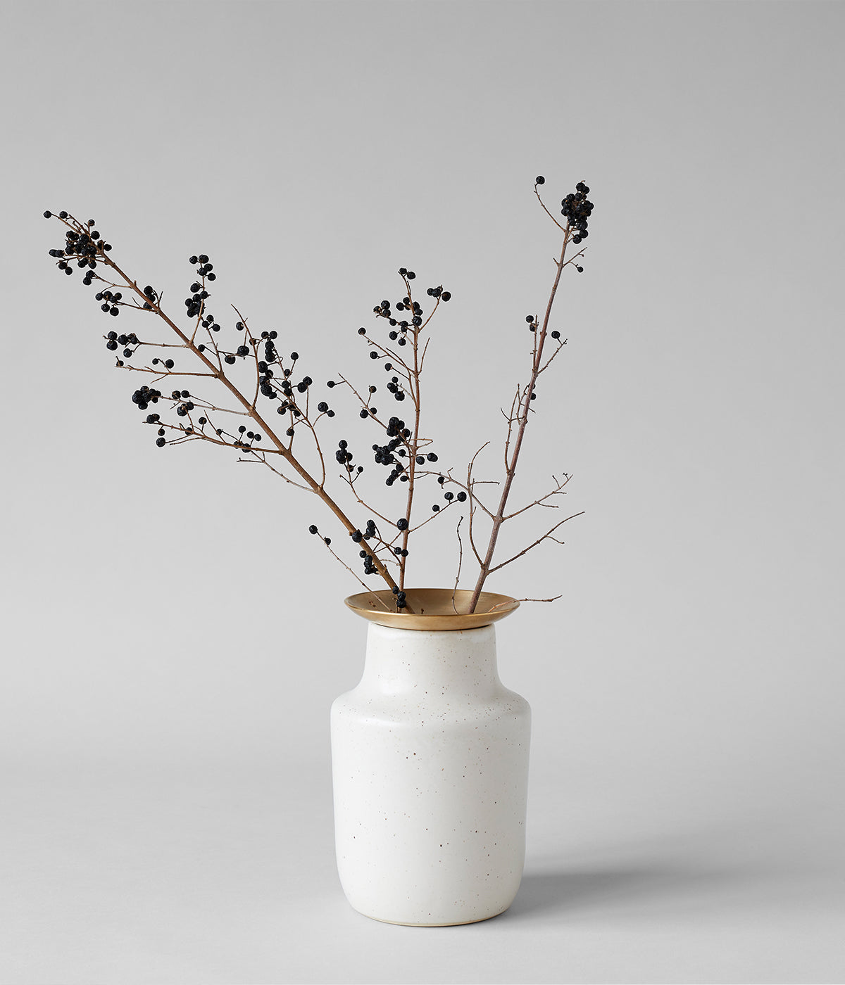 Hand cast brass floral frogs with ceramic vases designed for branches bulbs and stems