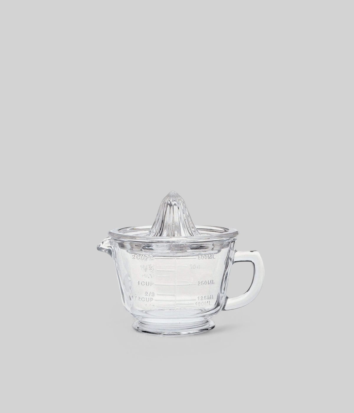 Classic glass citrus juicer with handle and spout for hand-pressed juice