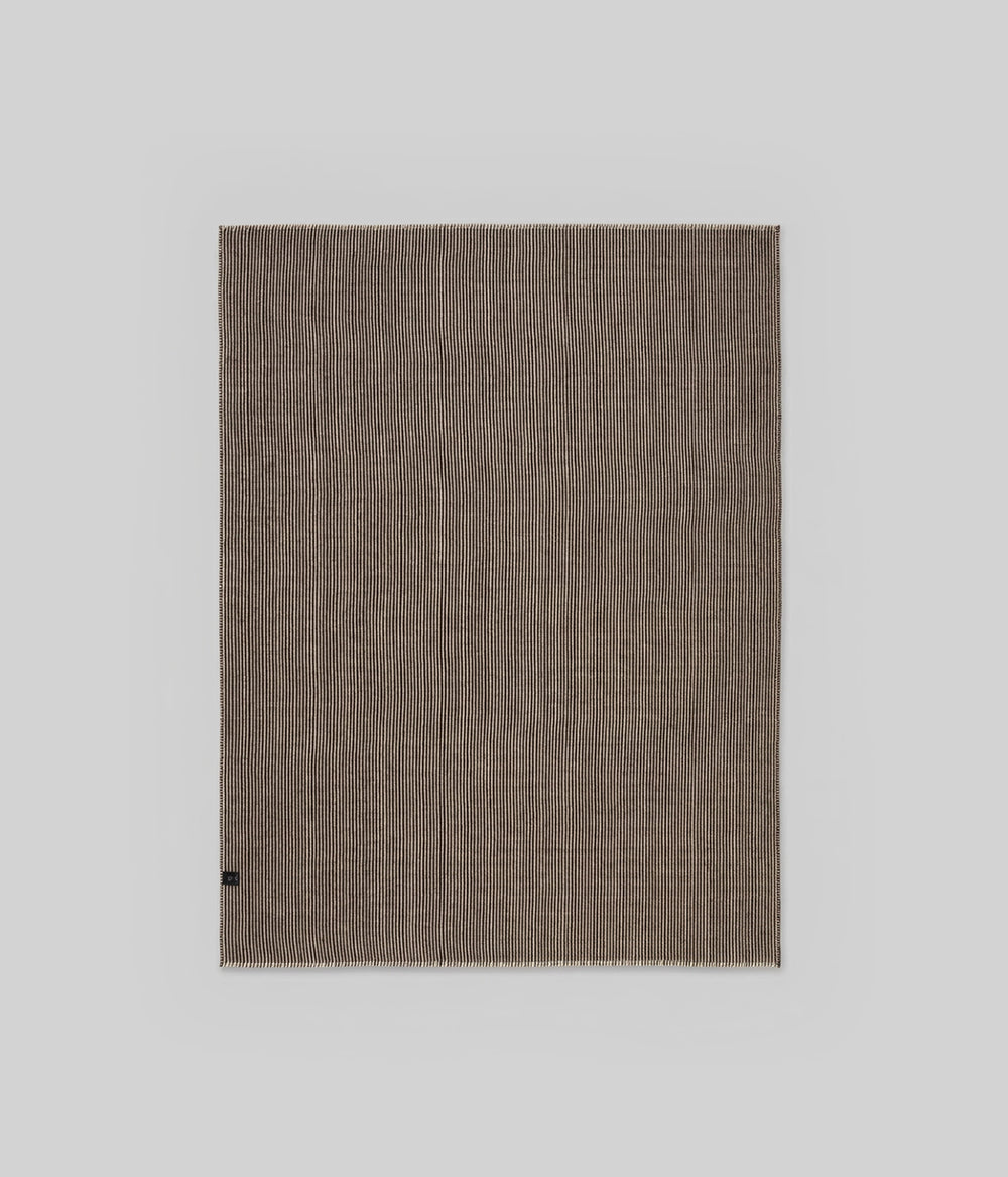 Cortez throw showing tight vertical stripe repeat across full 53x70 field