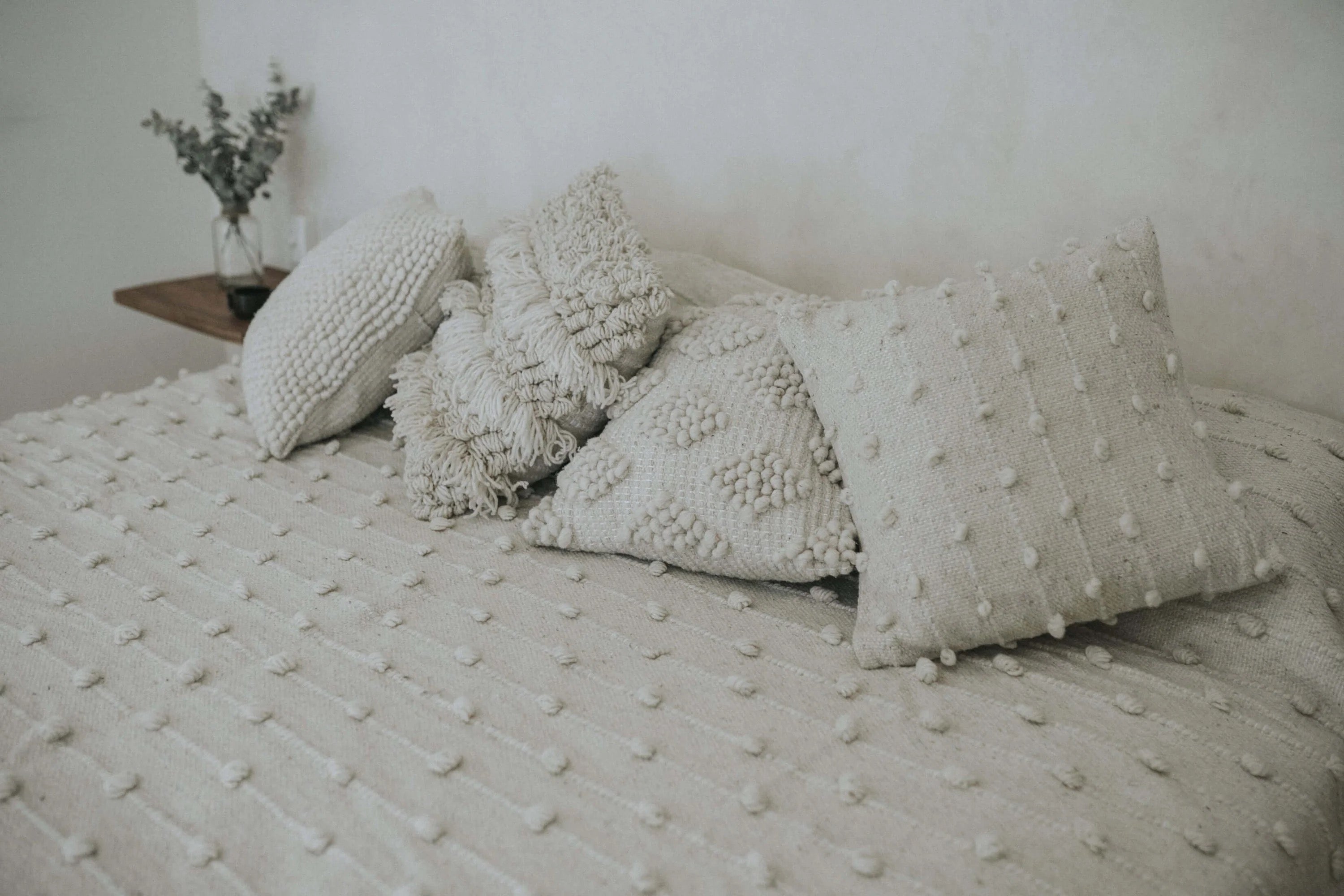 Ivory throw pillows with raised diamond weave pattern