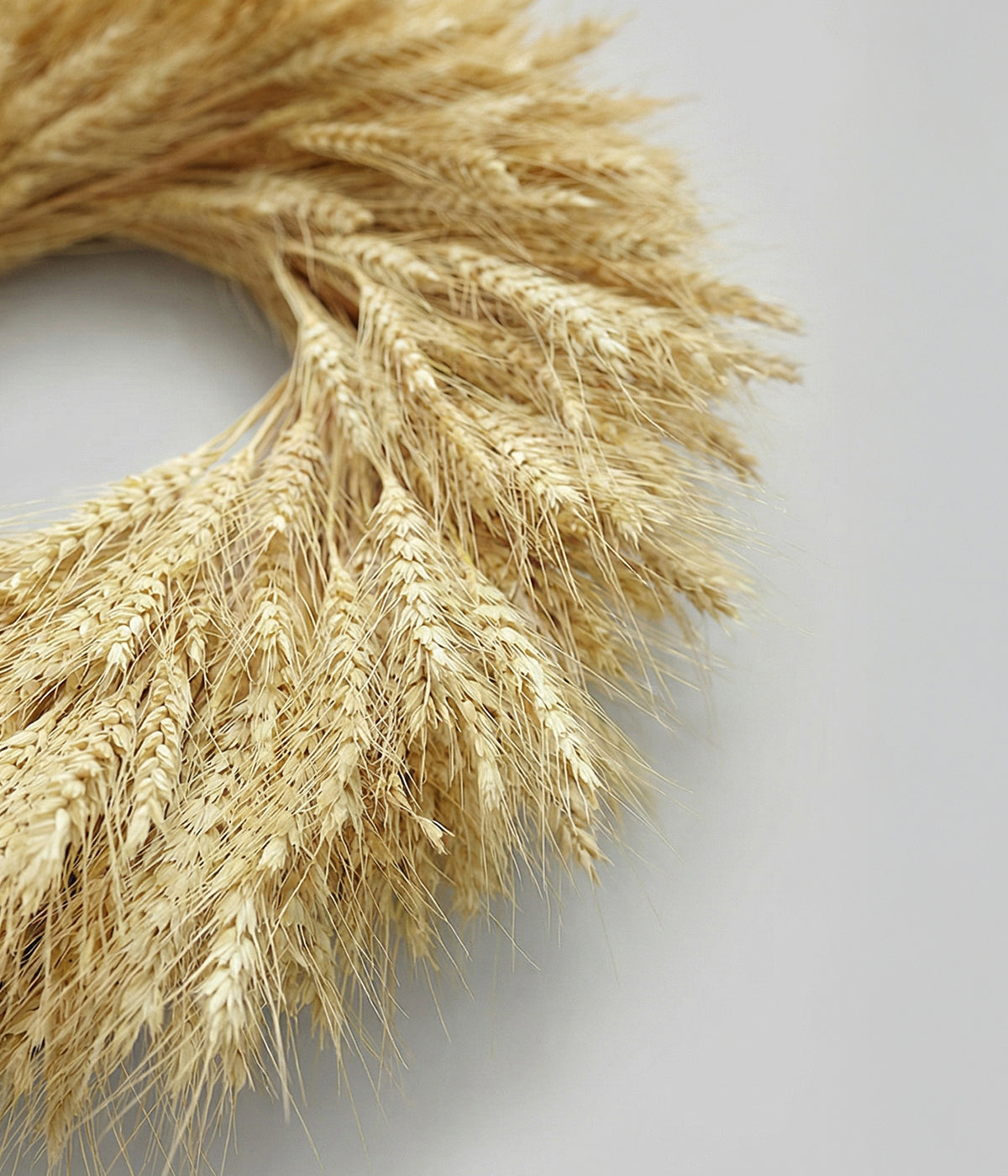 Close-up detail of blonde wheat wreath showing layered wheat heads