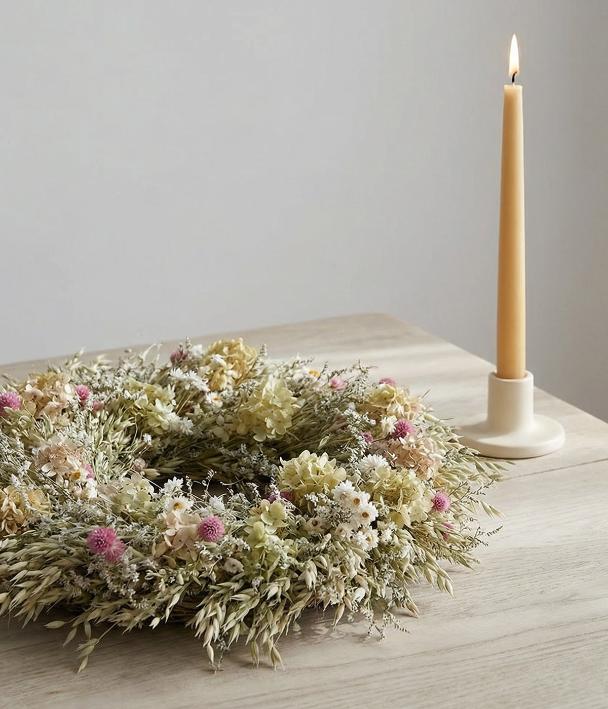 Eleanor wreath displayed flat on table as centerpiece with a candle