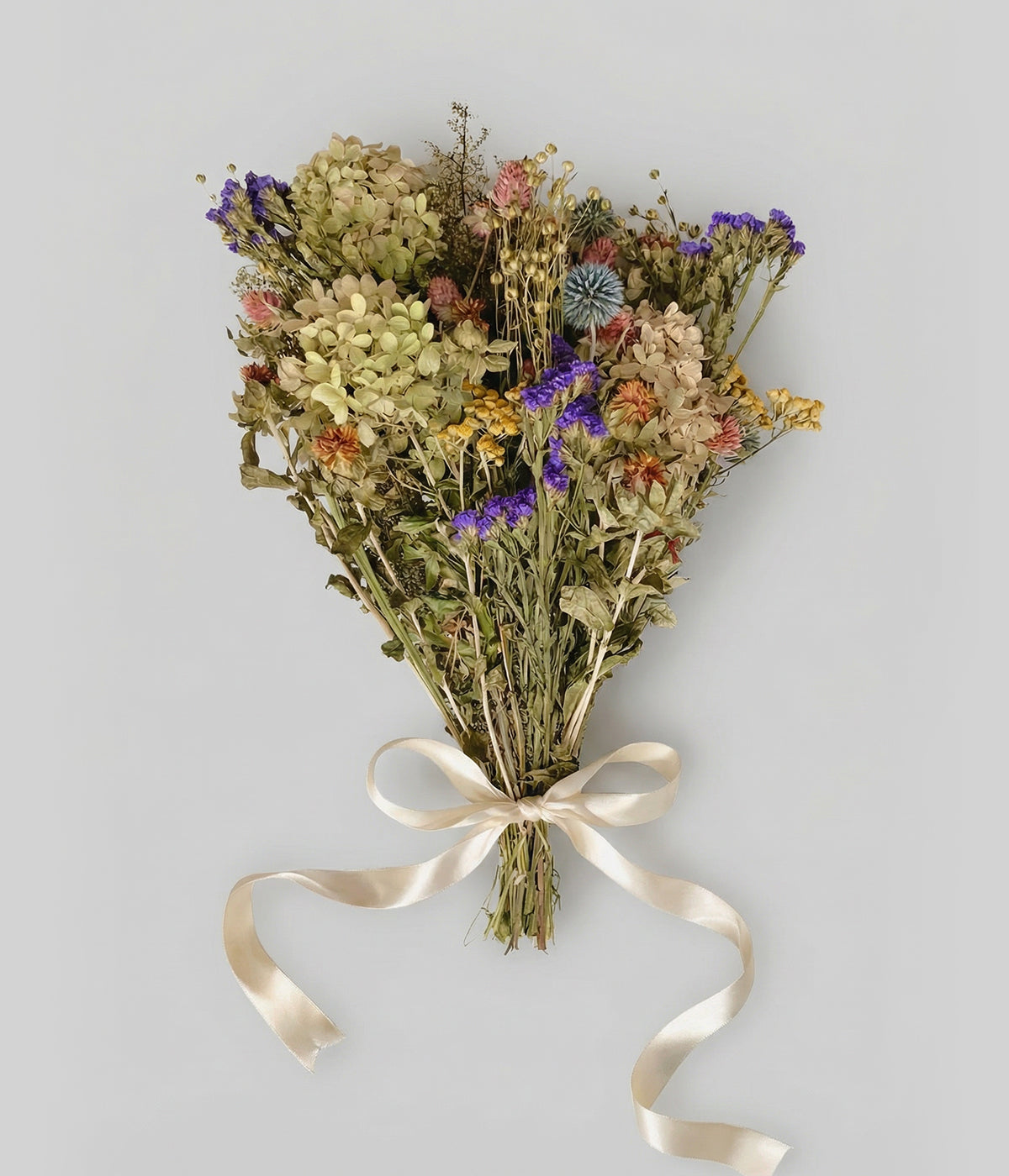 Elara dried wildflower bouquet with hydrangea, purple statice, and ivory satin ribbon on white