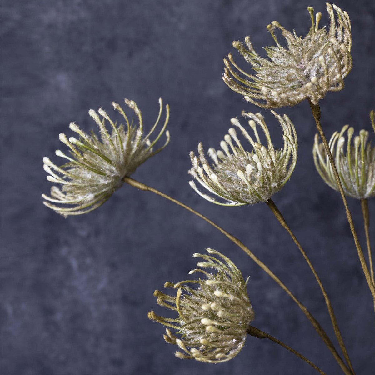 Artificial pincushion flower in soft green tones adds sculptural detail to floral displays