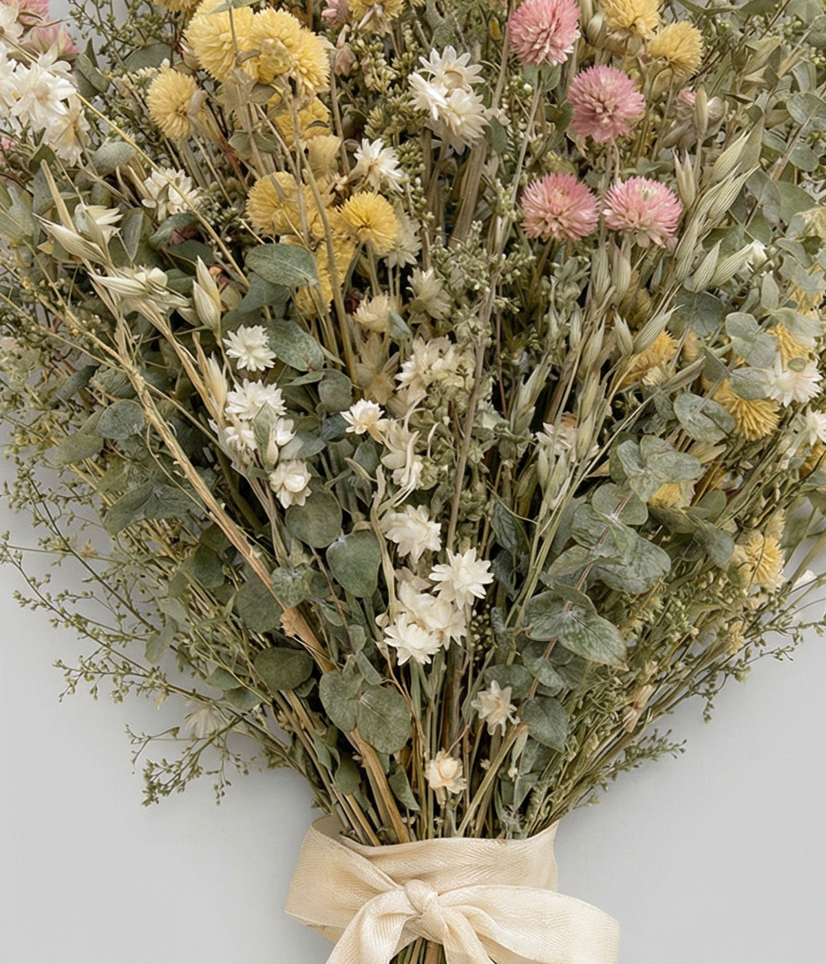 Close view of dried globe amaranth  bouquet with ammobium daisies