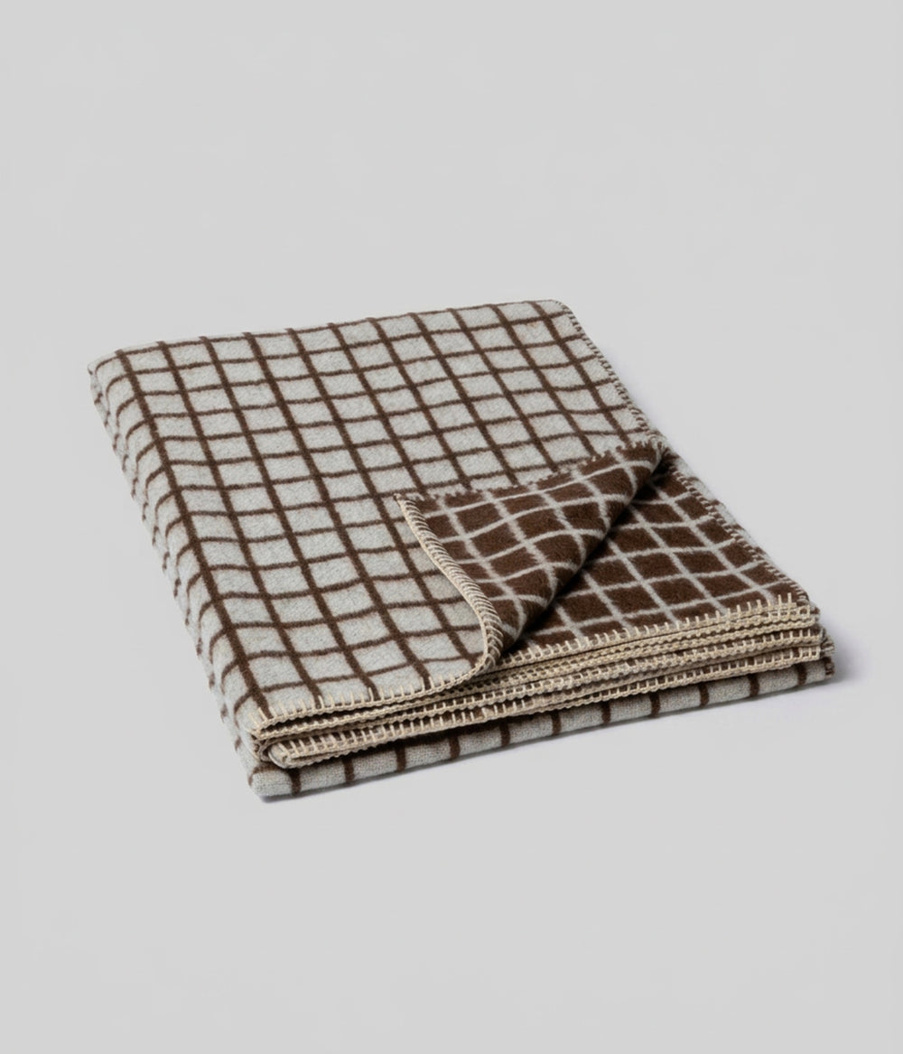 Floyd reversible throw showing ivory and coffee faces at folded corner