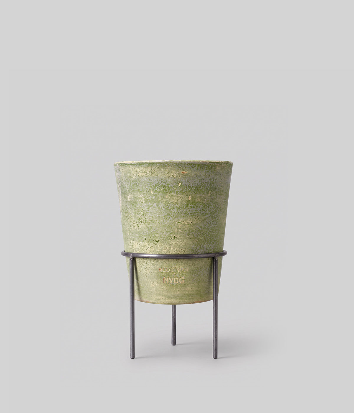 Medium Bloomist x NYBG Garden Sage planter with tapered profile and impressed branding, raised on a dark metal stand
