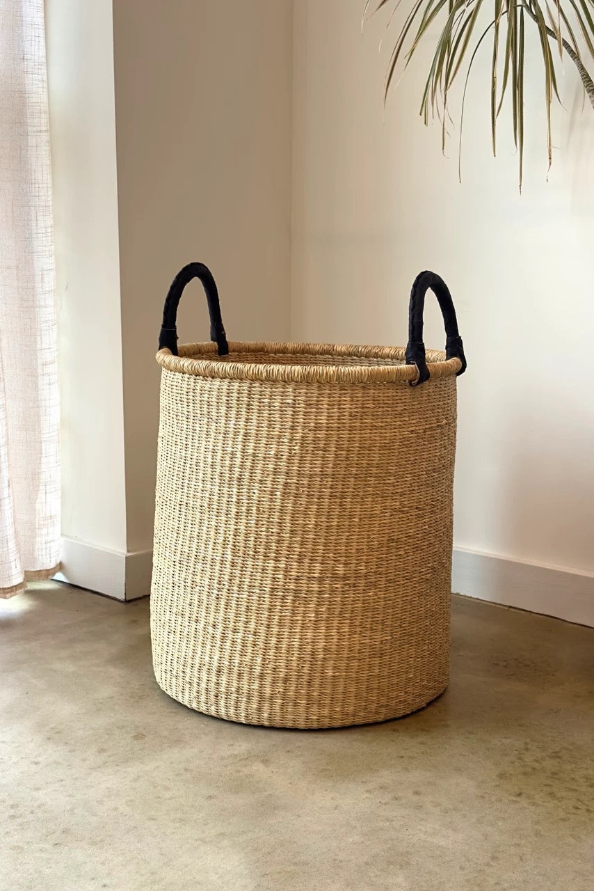 Large hamper basket with leather handles and structured form