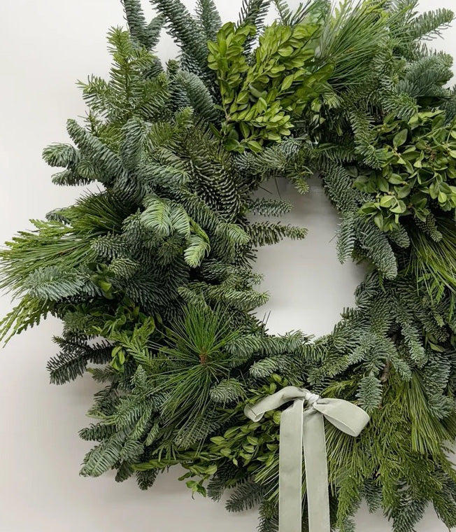 Close-up of Hazel traditional Christmas wreath with fresh boxwood, cedar, pine, fir, and sage velvet bow