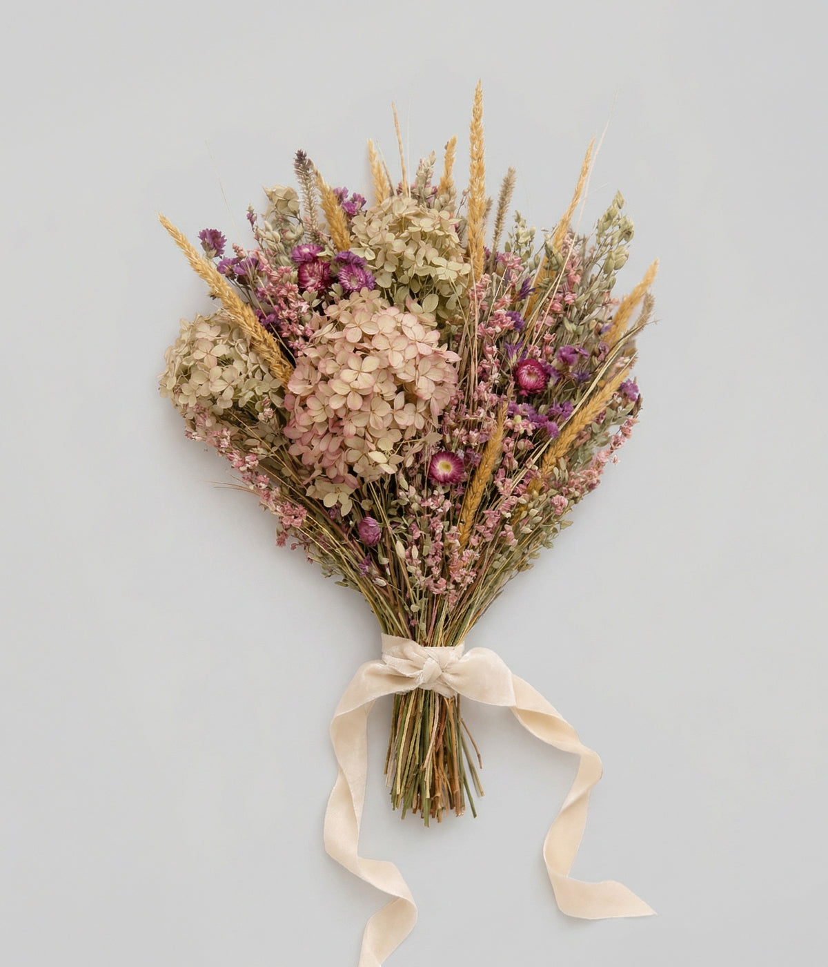 Dried hydrangea bouquet with limelight blooms, grasses, and layered botanicals