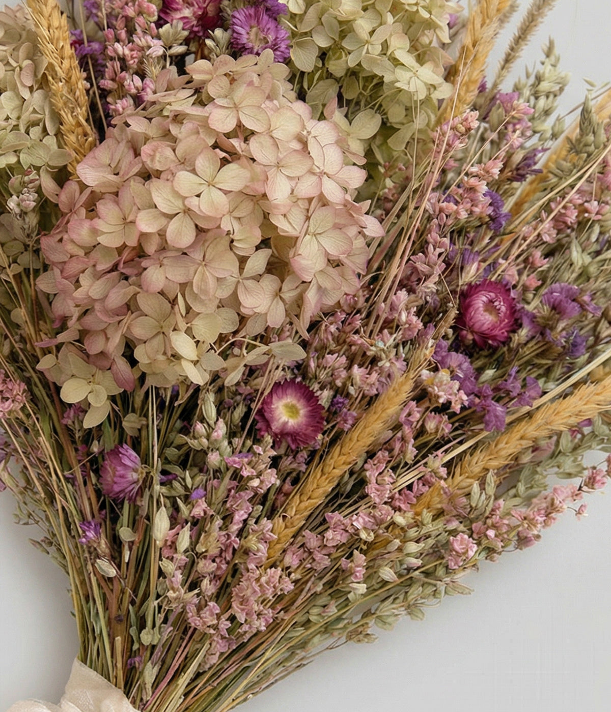 Close-up of dried hydrangea, strawflowers, and statice showing texture and scale