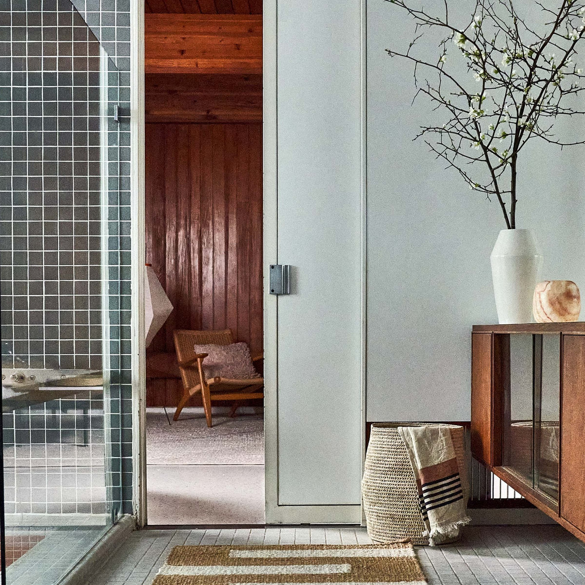 Artisan-crafted blush and striped guest towel styled in a modern home setting