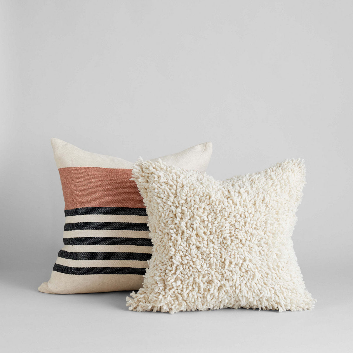 Artisan-crafted Belgian linen pillow in warm blush tones for layering in living room