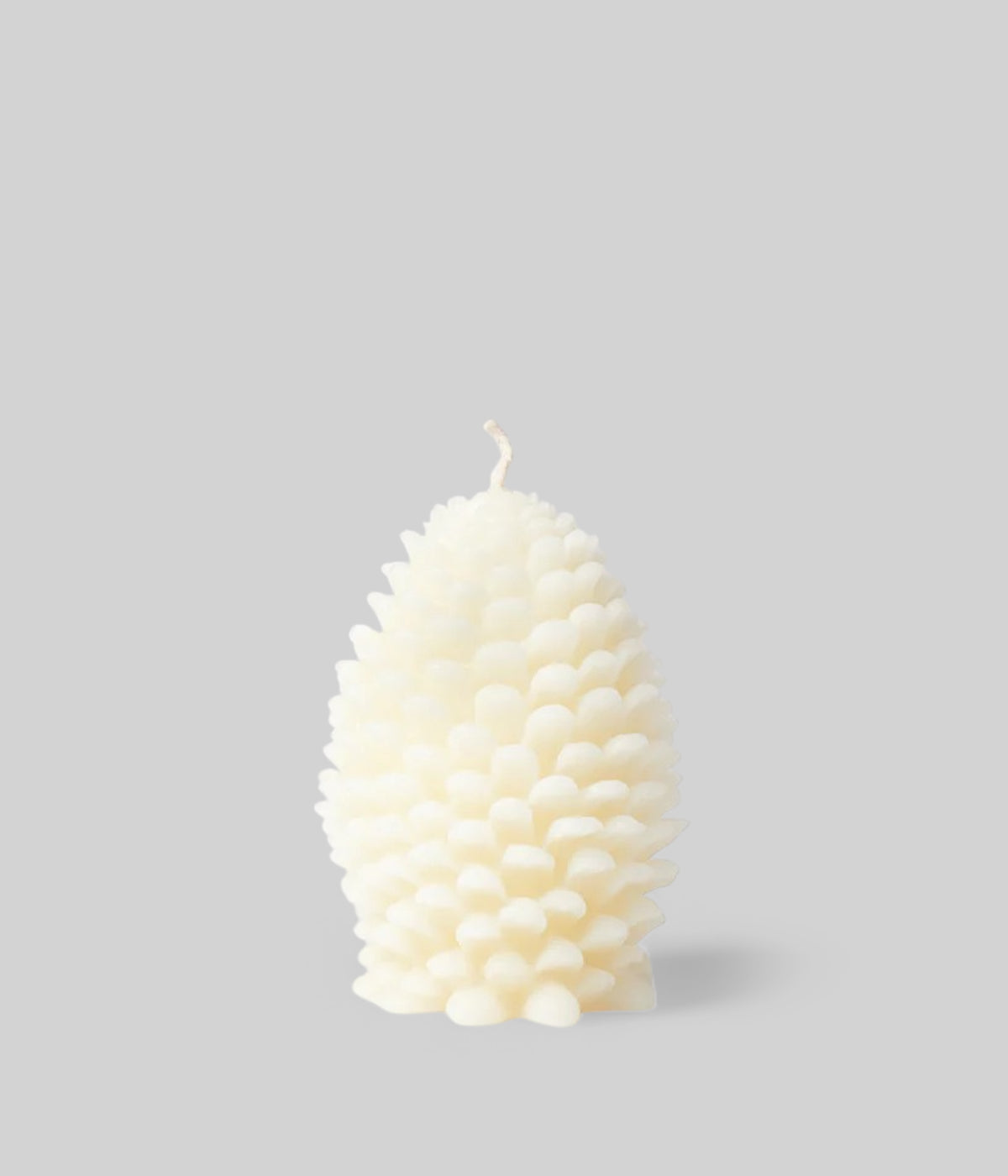 Cream jumbo cone candle as holiday table focal point