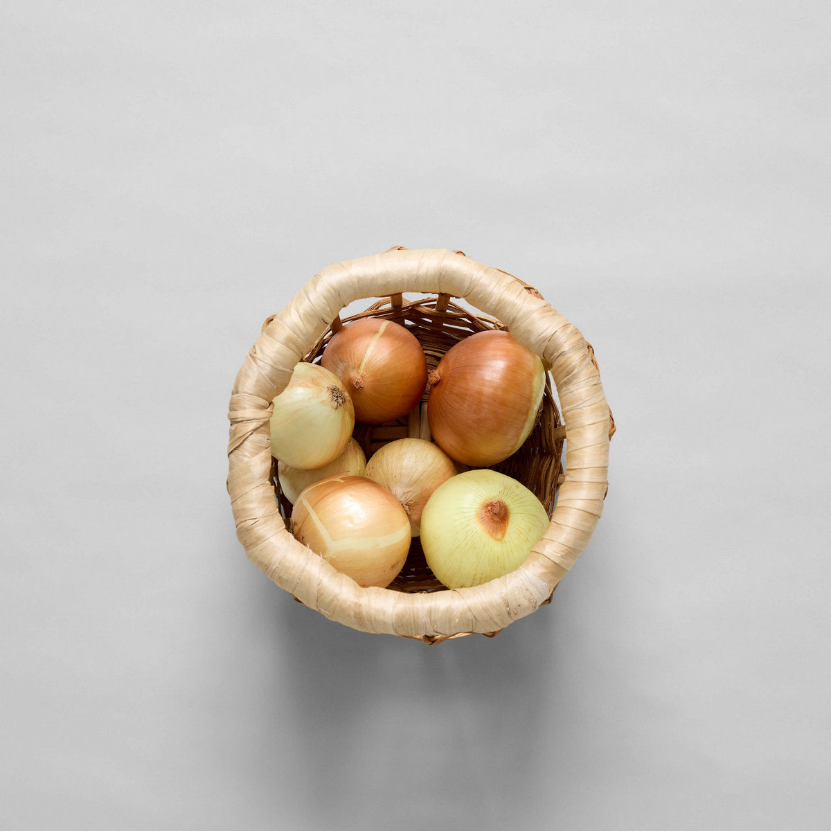Woven basket filled with assorted apples, top-down view