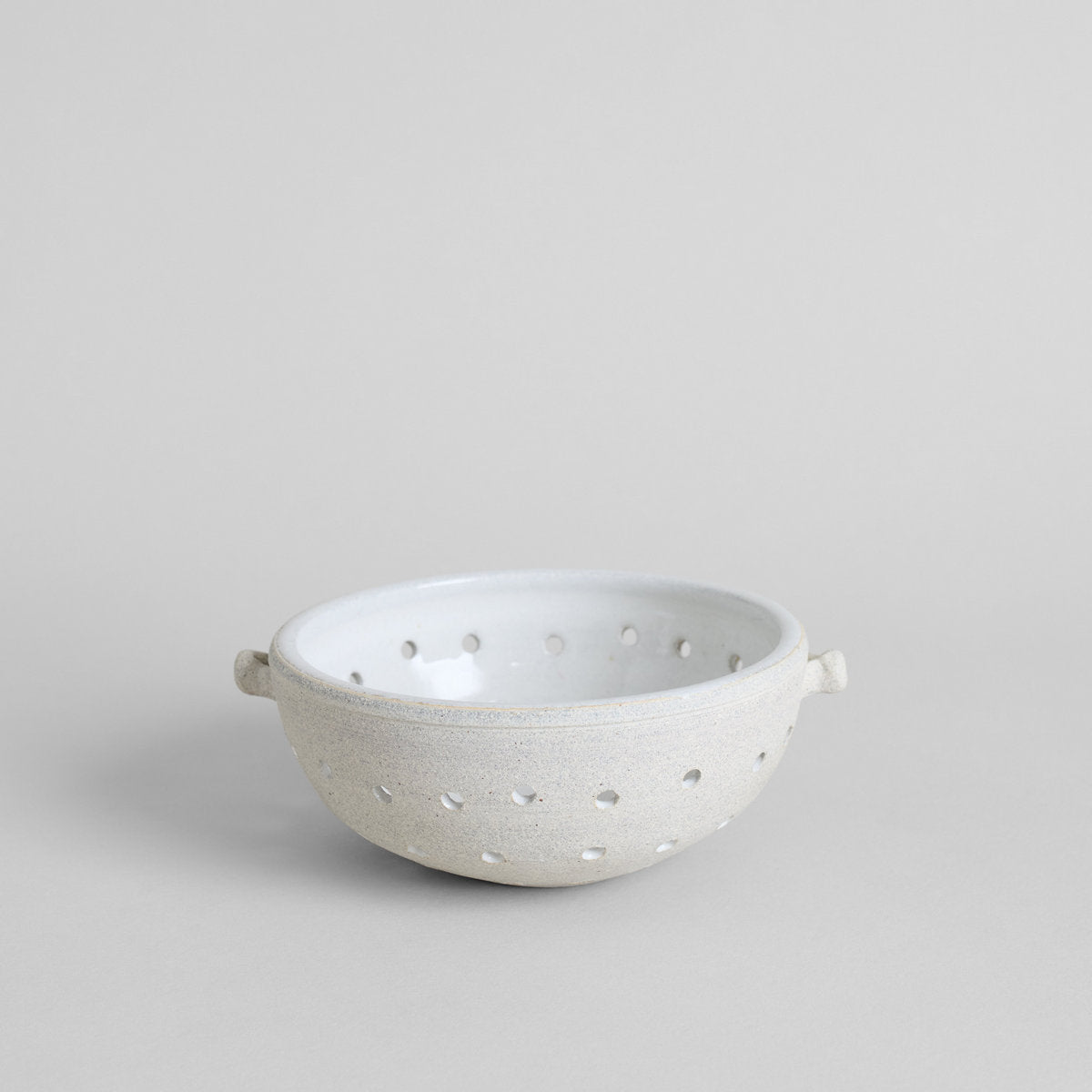 Vermont white ceramic colander with glazed interior and hand-perforated holes