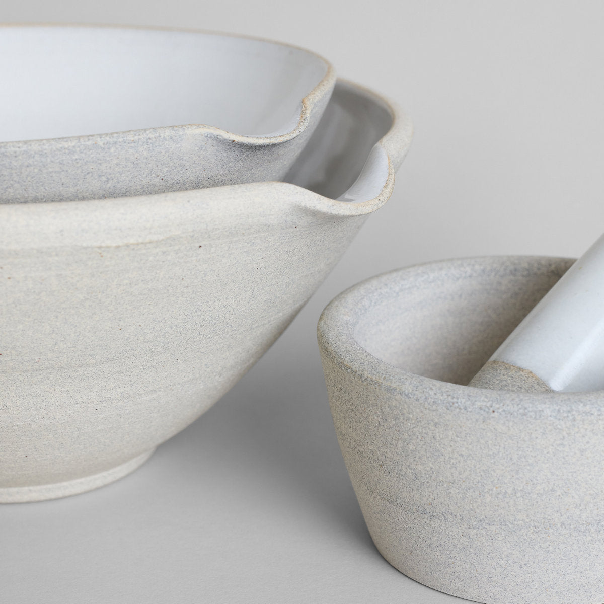 Stoneware mortar bowl with white glaze interior and matching pestle
