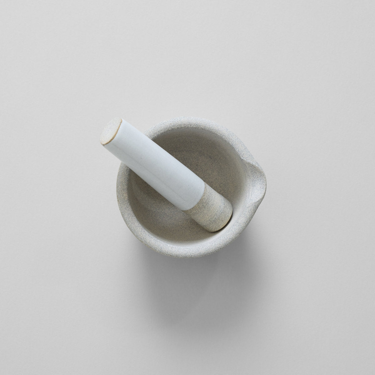 Stone mortar and pestle with broad rim and integrated pouring spout