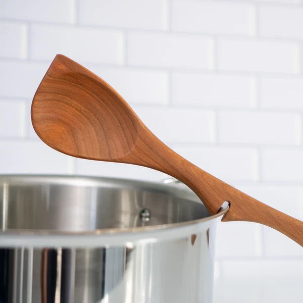 Wood spoons for cooking resting on a metallic pot