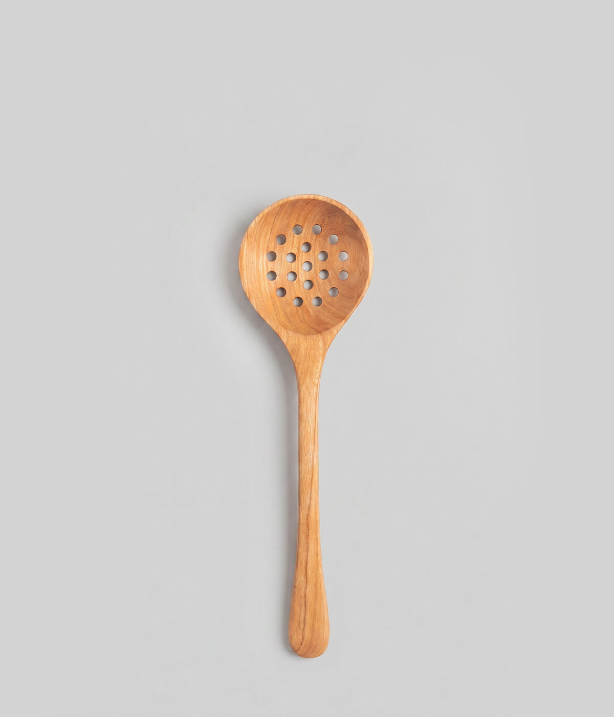 12" handmade wooden strainer spoon with a perforated design on a gray background