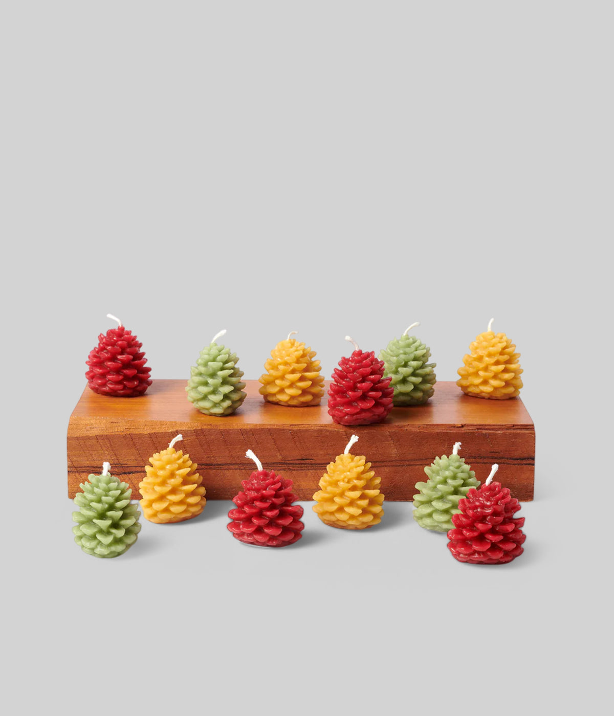 Tall white 12 inch taper candles with warm glow on festive table