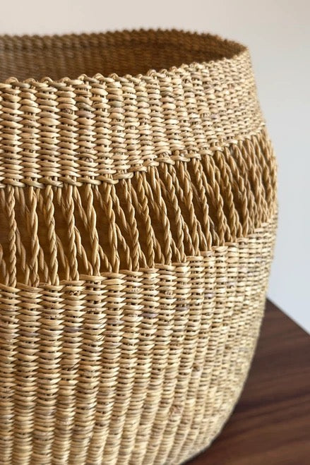 Upright Bolga basket for storage with wide open top
