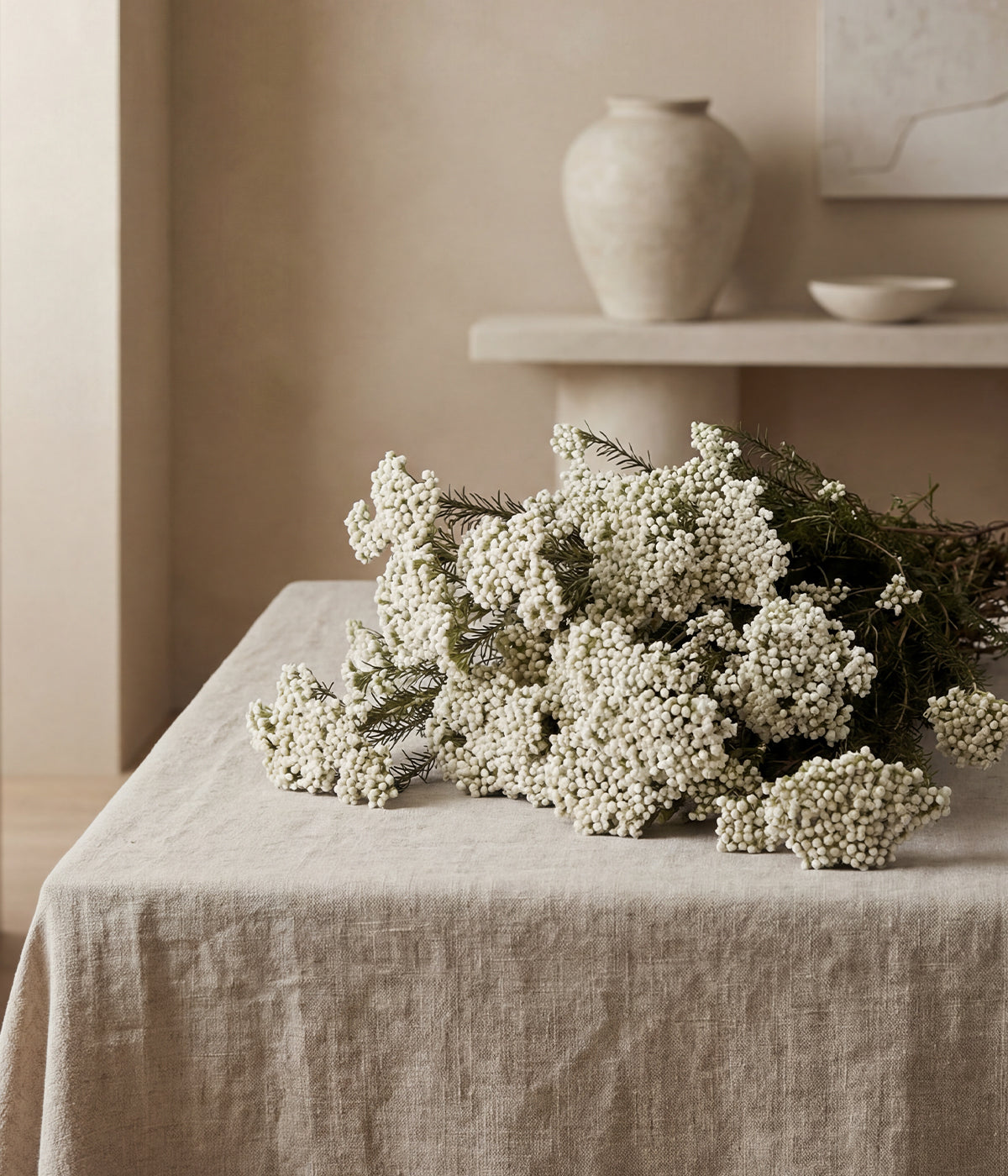Preserved sago bush on beige linen with ceramic pottery in natural light