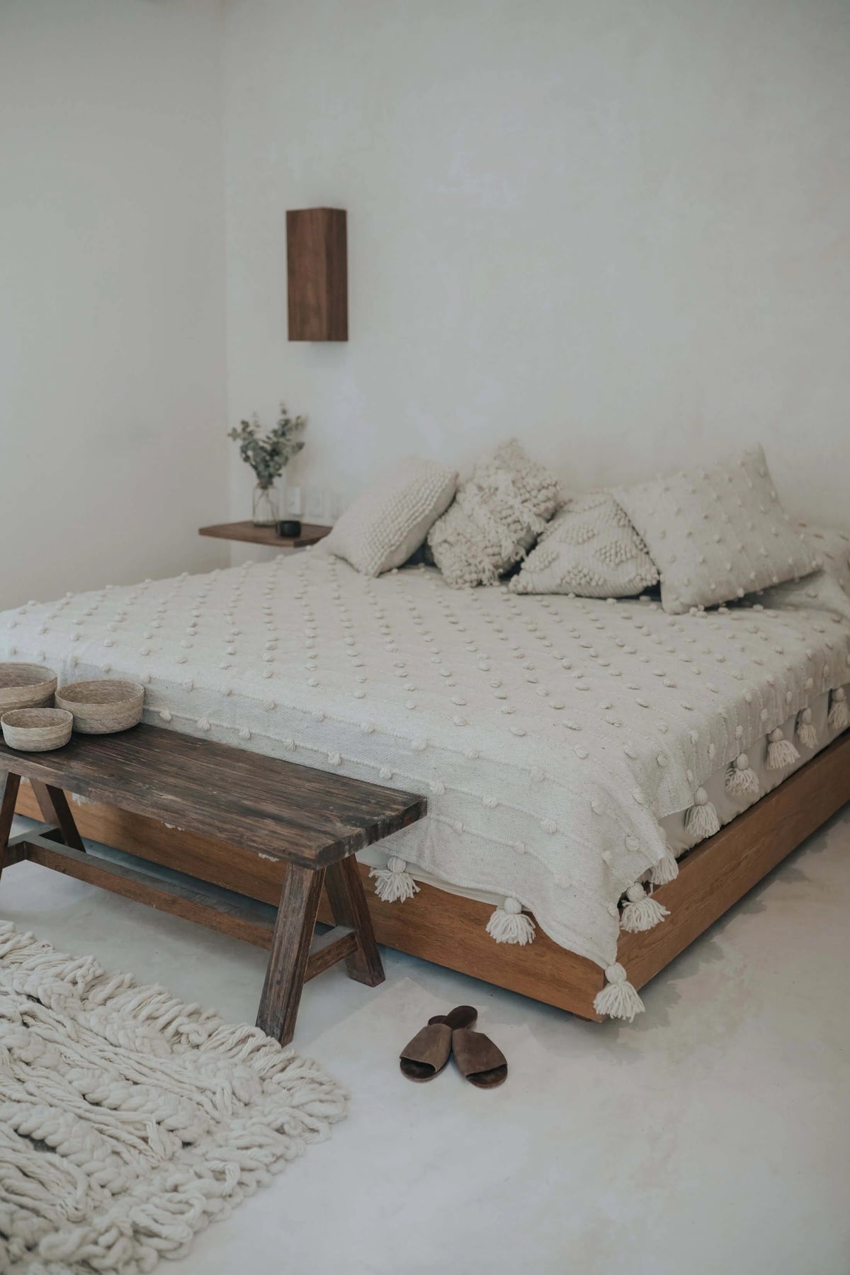Soft wool blanket with individually placed pompom dots and tassels