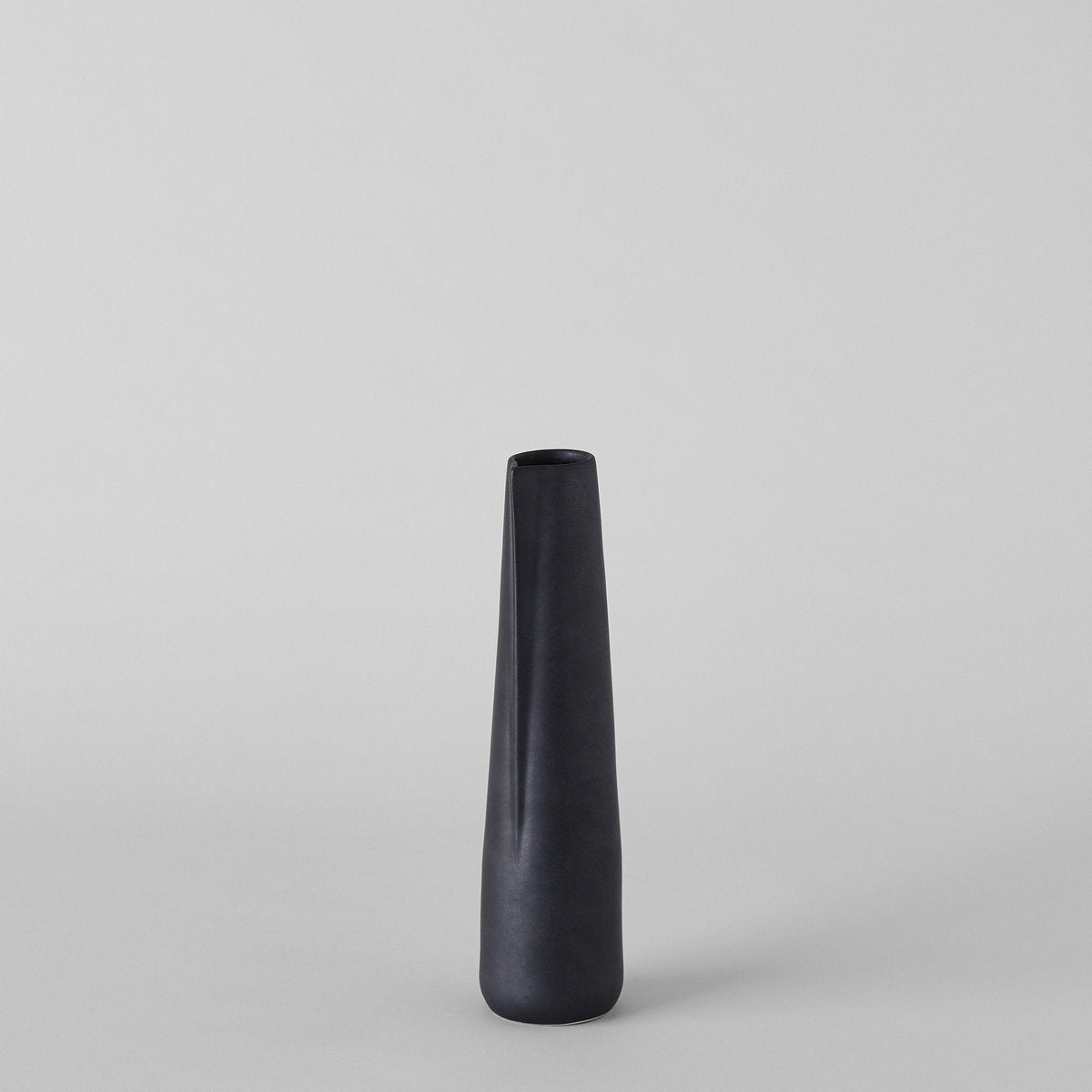 Tall matte black ceramic pitcher for holiday greenery or dried winter stems