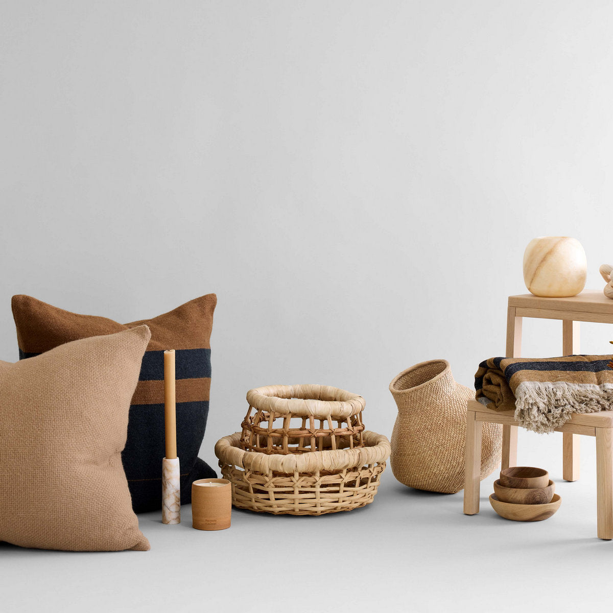 Decorative setup featuring woven baskets, and ceramic vases