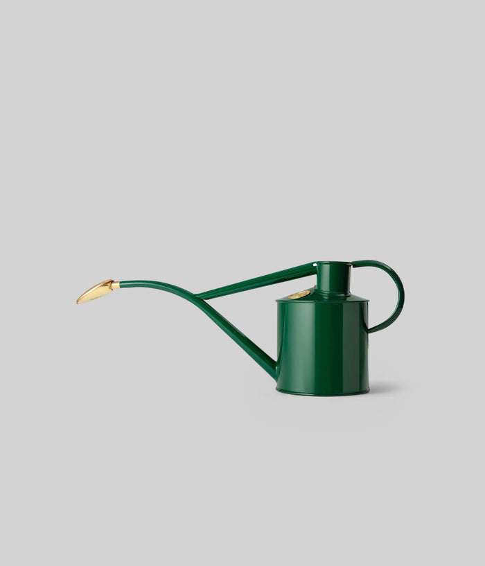 Haws green metal watering can with long spout and brass rose, ideal for precise outdoor plant care