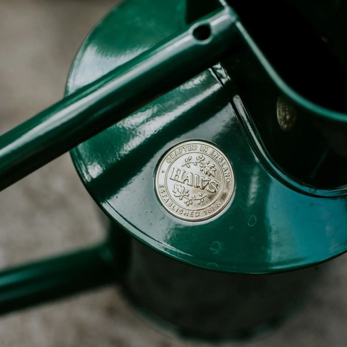 Haws green watering can in galvanized steel with signature emblem and balanced design