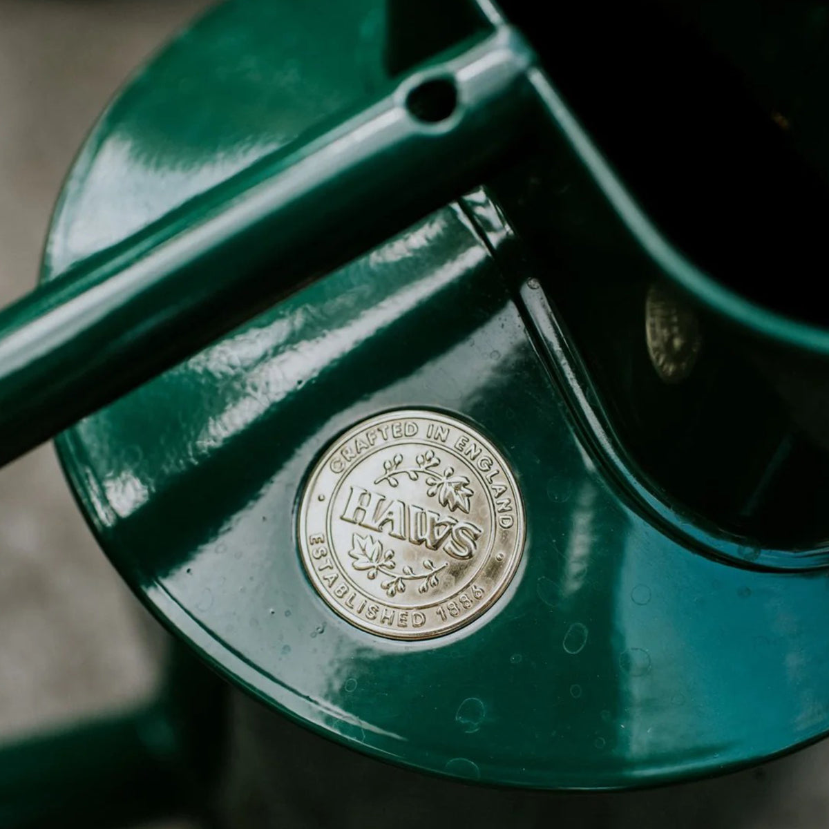Decorative metal watering cans in classic green with long spout and signature Haws emblem