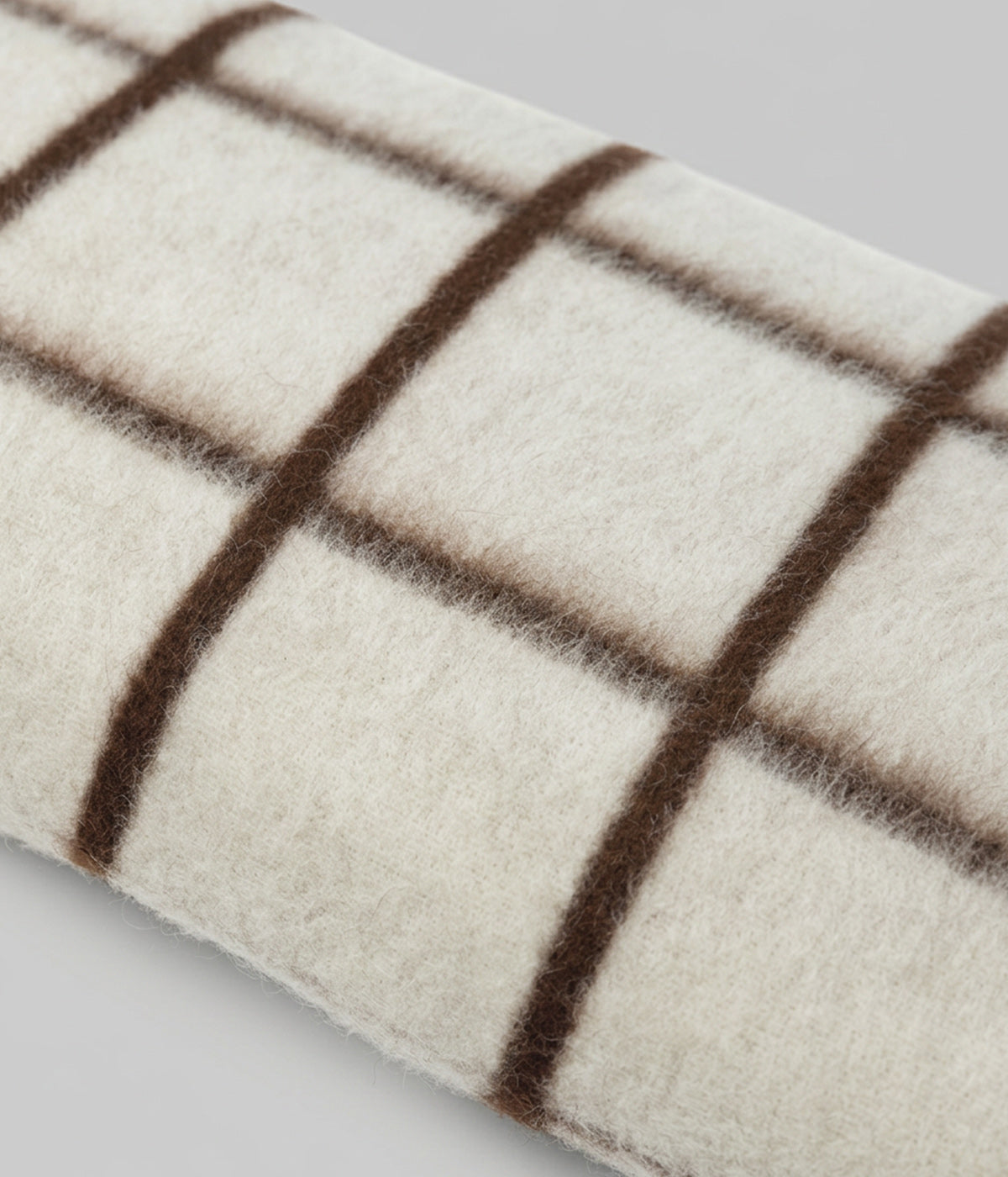 Umi lumbar close-up showing bold windowpane grid across full face