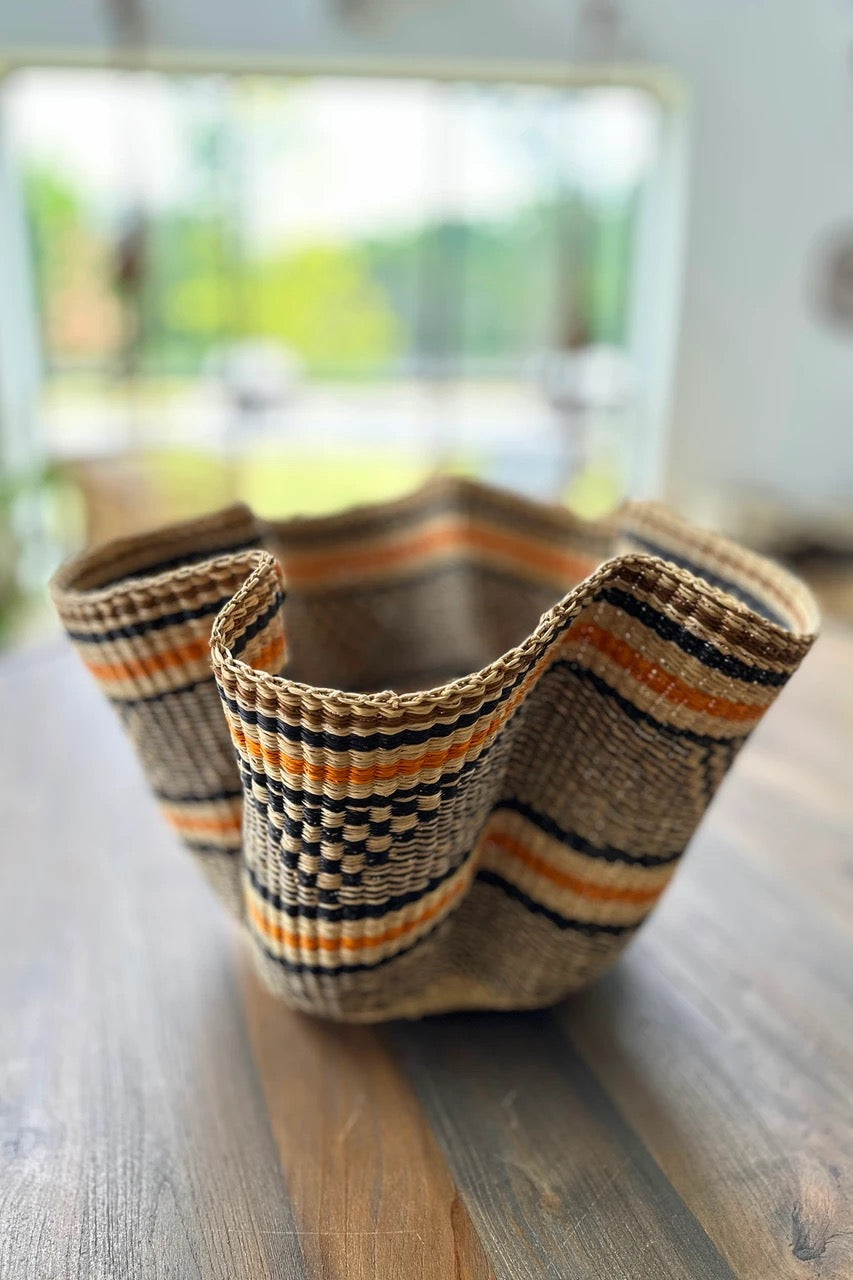 Elephant grass basket with petal opening and geometric weave center