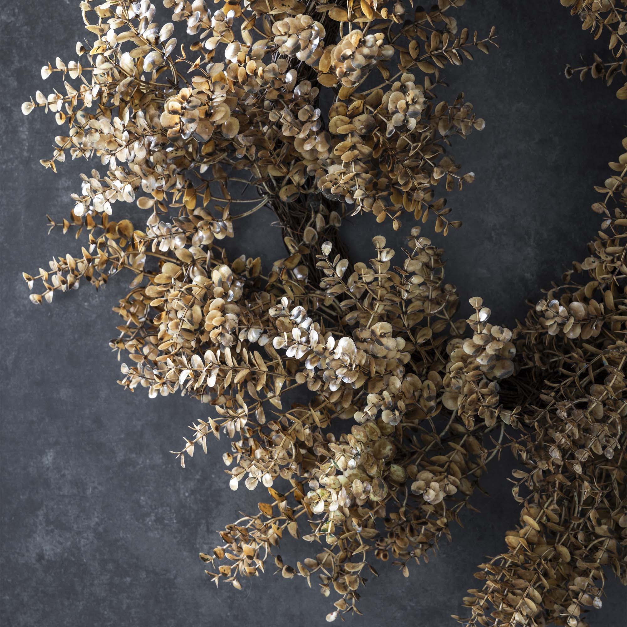 Faux greenery wreath featuring lifelike eucalyptus leaves in earthy green tones