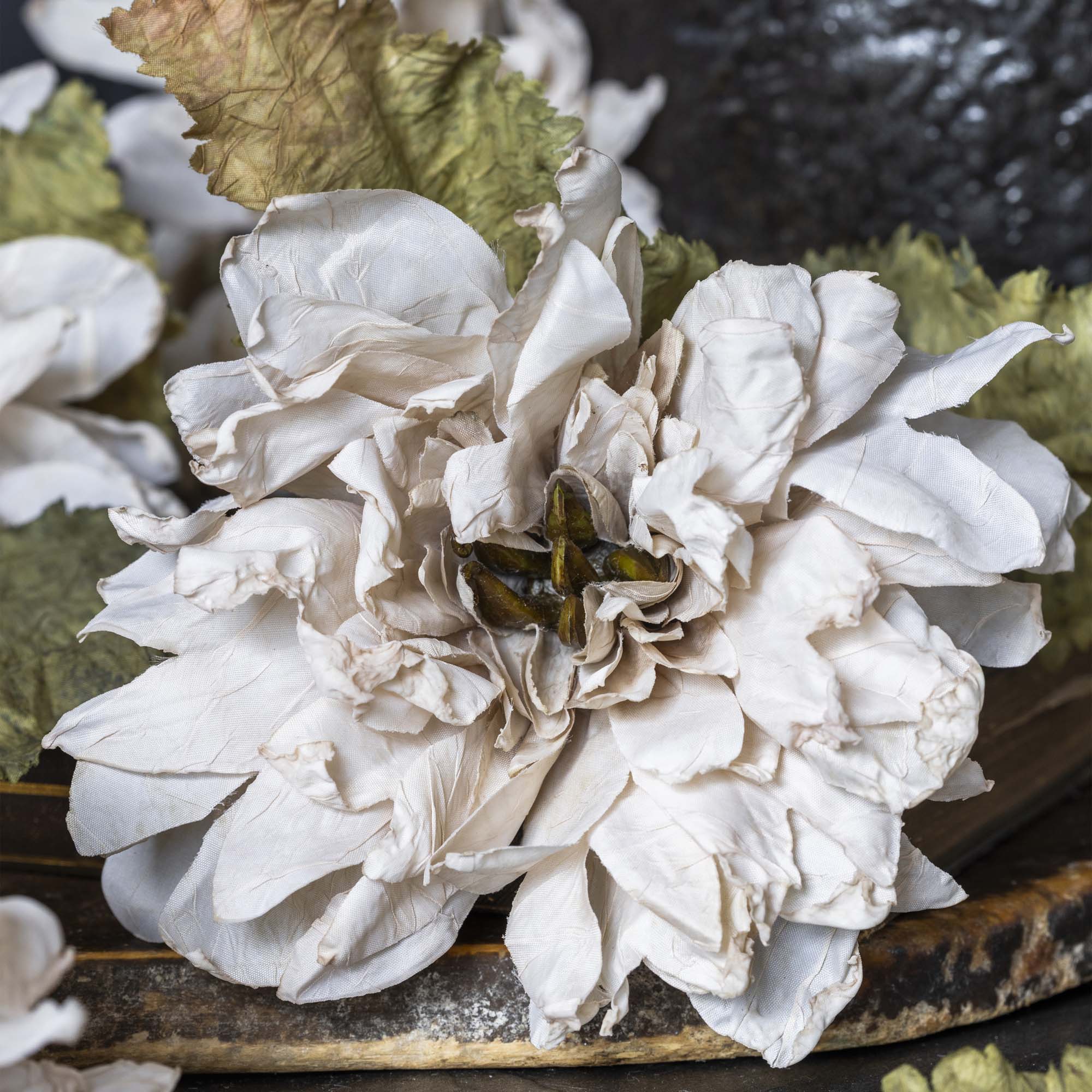 Close-up of artificial dahlia flower bloom in blush ivory with layered petals