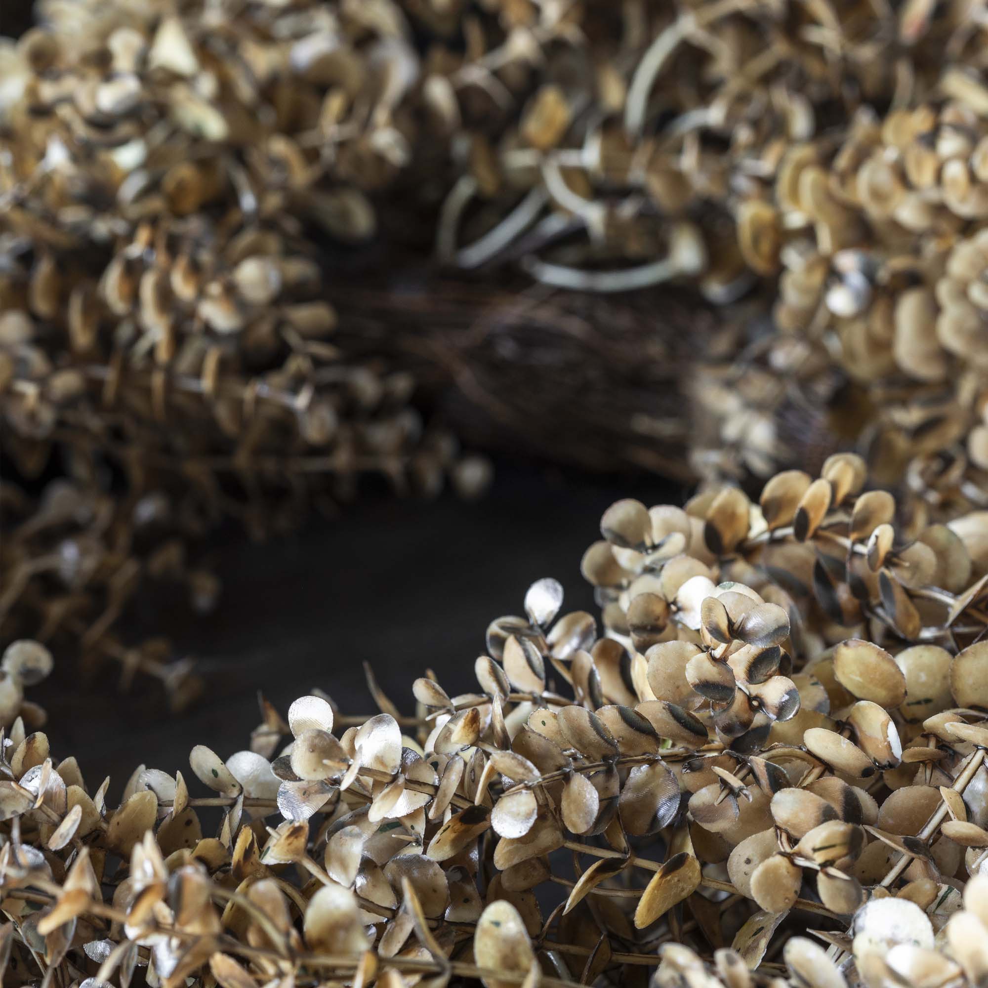 Decorative artificial botanical wreath with eucalyptus leaves in desert tones