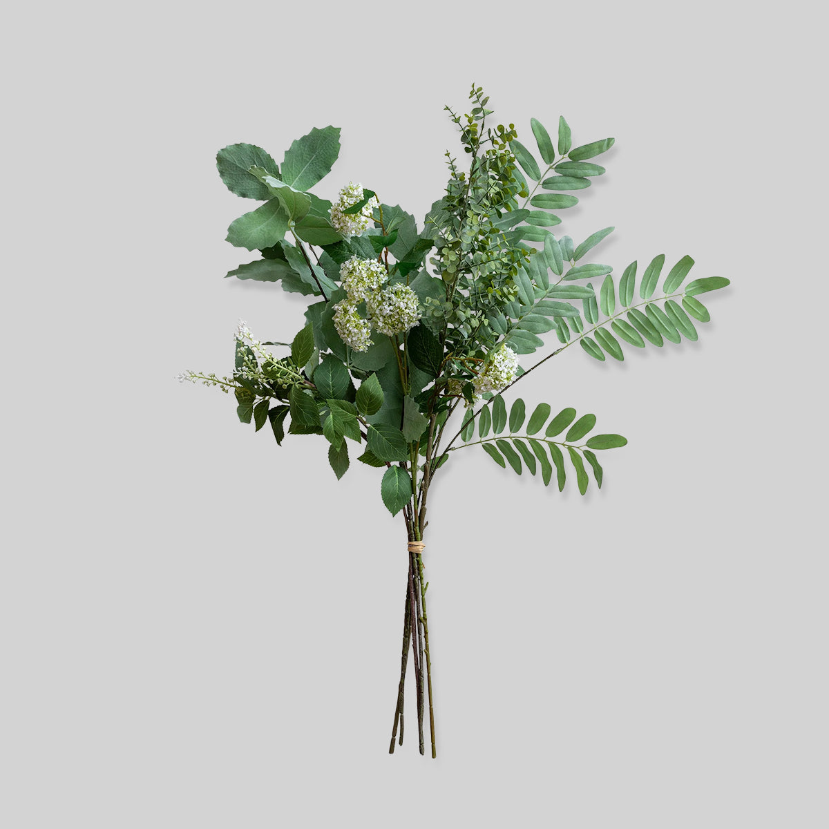 Faux foliage bunch with mixed greenery and layered leaves on white background