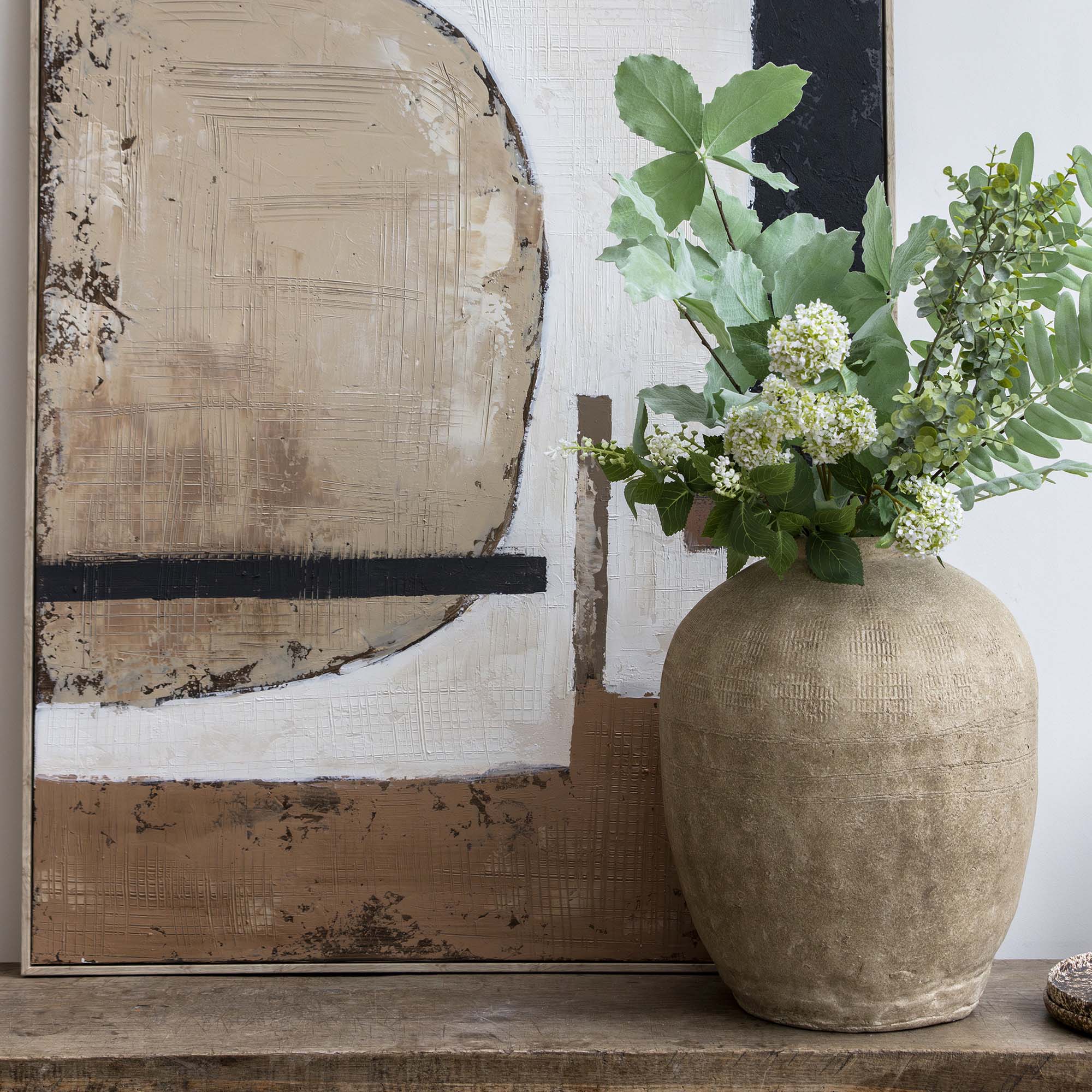 Pre-arranged summer foliage bunch styled in a large ceramic vase with layered greenery