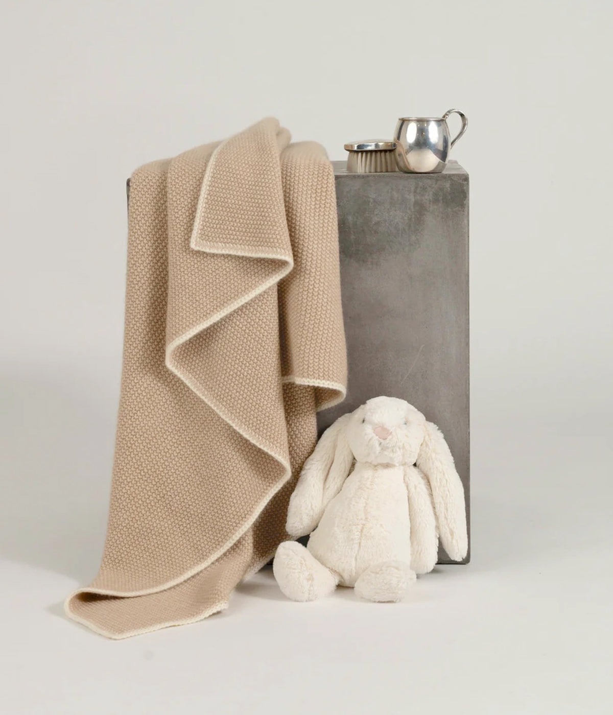 beige cashmere baby blanket with white border