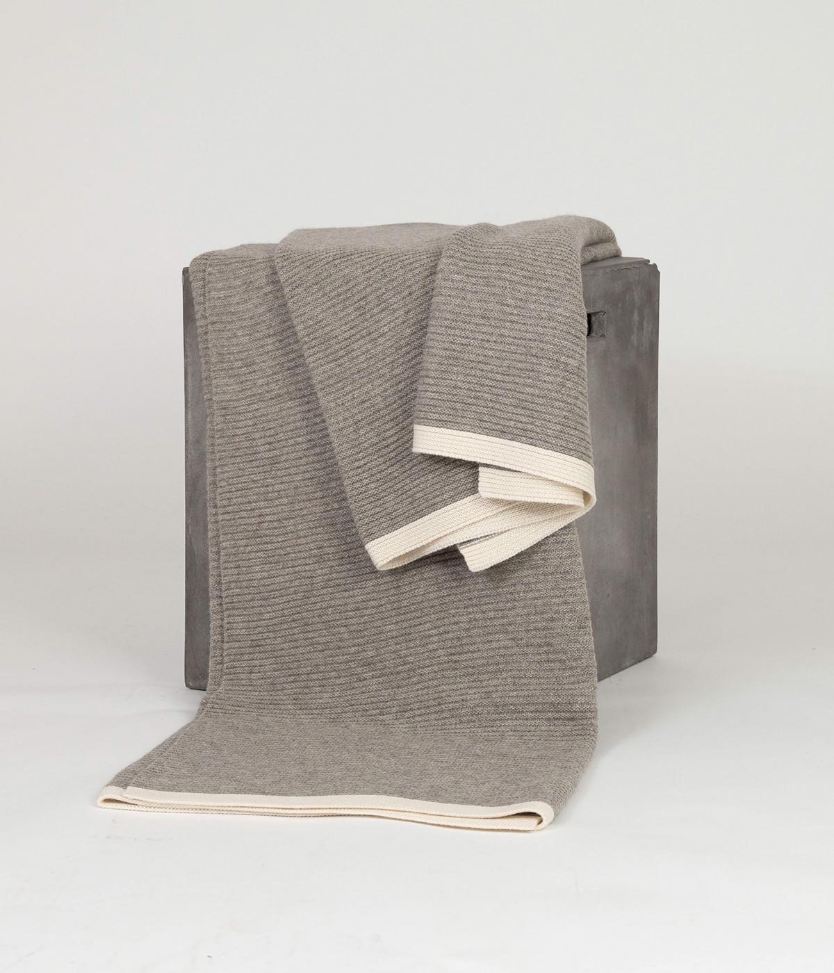 Handwoven platinum and white knit  throw blanket made from yak down with soft cashmere borders